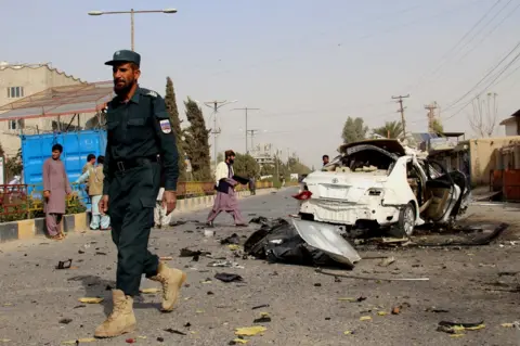 EPA Afghan security officials inspect the scene of a IED blast in Lashkargah, the provincial capital of Helmand, Afghanistan, 12 November 2020.