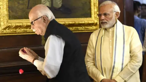 Getty Images Prime Minister Narendra Modi (R) and Senior BJP leader L K Advani pay tribute at Parliament House on July 6, 2018 in New Delhi.