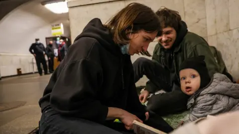 Reuters People gather at a metro station as they seek shelter from expected Russian air strikes, in Kyiv