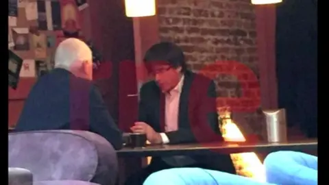Radio Television Espanola Screengrab with watermark shows Carles Puigdemont in a Belgian cafe on the day he was due in Madrid