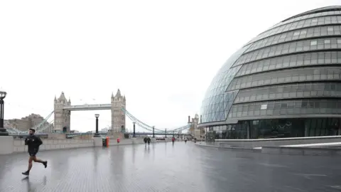 PA Media Man runs outside City Hall in London