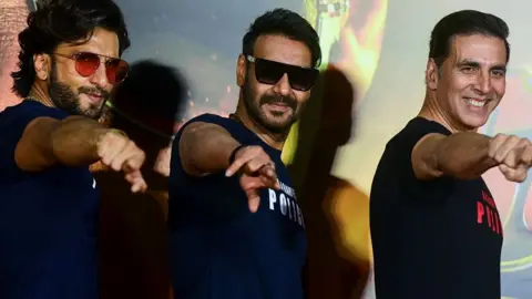 Getty Images Bollywood actors Ranveer Singh (L), Ajay Devgn (C) and Akshay Kumar pose for a picture during the trailer launch of their upcoming action Hindi film 'Sooryavanshi' in Mumbai on March 2, 2020. (Photo by Sujit Jaiswal / AFP) (Photo by SUJIT JAISWAL/AFP via Getty Images)