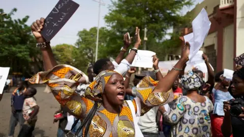 AFP A demonstrator hold up a sign: "We want to study"