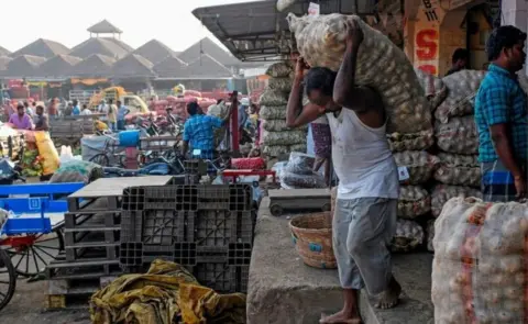 Getty Images Many farmers sell produce at large wholesale markets or mandis