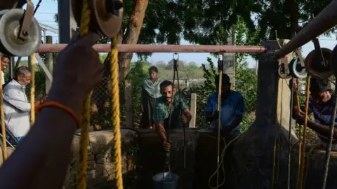 Getty Images In this photo taken on June 20, 2019, Indian residents collect water from a community well in Chennai after reservoirs for the city ran dry.