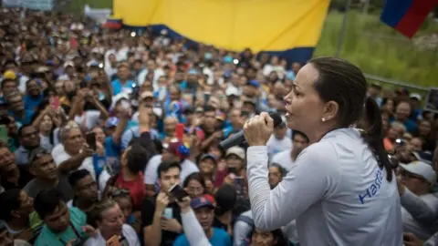 Venezuelan presidential pre-candidate Maria Corina Machado (R) participates in a political act on an avenue in Maracay, Venezuela, 28 September 2023.
