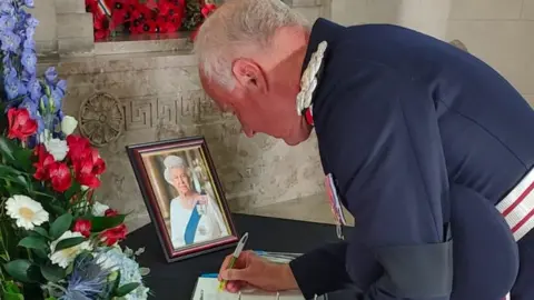 BBC Lord Lieutenant of the West Midlands John Crabtree signs a book of condolence