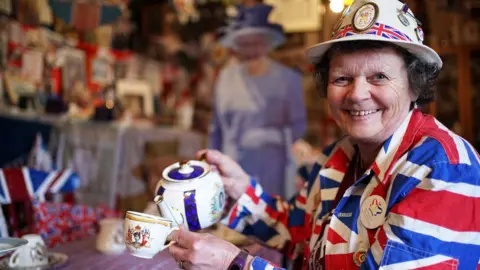 Anita Atkinson pours tea from royal teapot