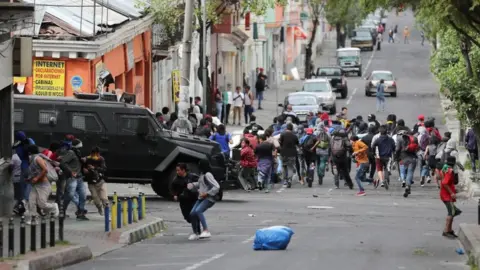 Reuters Demonstrators run away from an armoured vehicle during protests against fuel subsidy cuts