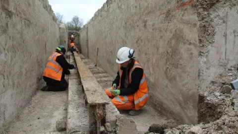 MOLA Archaeologists excavating one of the catapult's arms