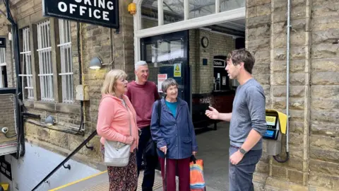 Scott Patient speaking to passengers about the proposed closures at Hebden Bridge Rail Station