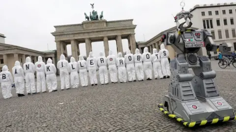 Getty Images Ban Killer Robots protest with robot in front of campaigners at Brandenburg Gate in Berlin