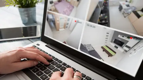 Getty Images watching a house through laptop