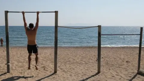 Reuters A man exercises on a beach, following the coronavirus disease (COVID-19) outbreak, in Athens, Greece, April 28, 2020