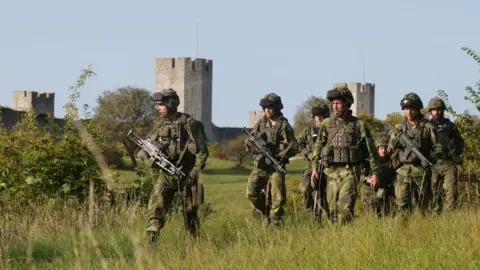 Getty Images This picture taken on 14 September 2016 shows Swedish military patrolling outside Visby, on Gotland island, Sweden