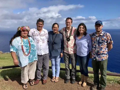 Chilean Ministry of National Assets Anakena Manutomatoma (first from left) and Felipe Ward (third from right) pose for a photo on Rapa Nui