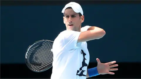Getty Images Novak Djokovic of Serbia practices on Rod Laver Arena ahead of the 2022 Australian Open at Melbourne Park on January 11, 2022 in Melbourne, Australia.