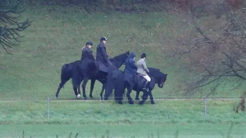 REUTERS/Peter Nicholls Duke of York and Queen ride horses in grounds of Windsor Castle