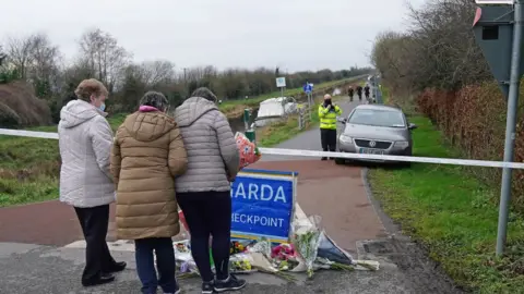 Brian Lawless/PA Wire Floral tributes have been laid at the cordon