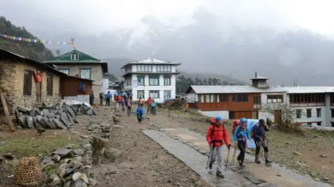 Getty Images Two climbers set off with their guide towards Everest Base Camp