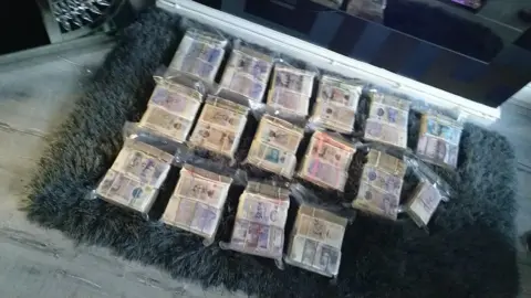 Police handout Photo of £385,000 in cash