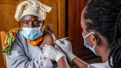 Getty Images Elderly woman receives the AstraZeneca vaccine