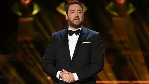 Getty Images Jason Manford on stage at the Olivier Awards