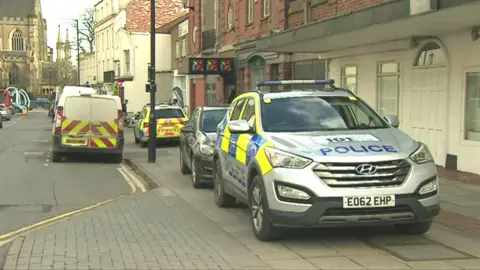 BBC The Assembly with police cars outside
