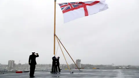 Andrew Matthews/PA Raining White Ensign