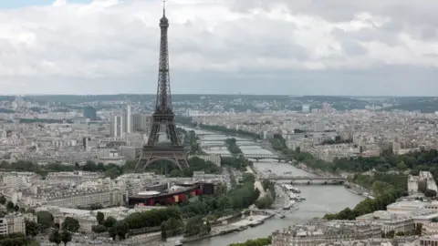 AFP/Getty Images This aerial picture taken on July 14, 2012 shows a general view of Paris with the Eiffel Tower (L) and the Seine River.