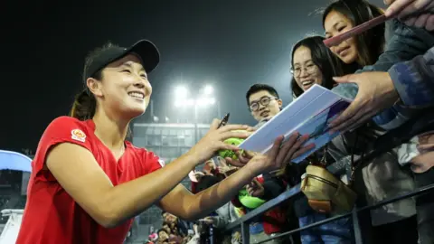 Getty Images Chinese tennis player Peng Shuai signing autographs