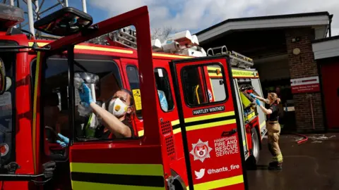 Getty Images Firefighters have to disinfect the fire truck and equipment every time it is called to an emergency to curb the spread of the virus