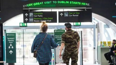 Brian Lawless/PA Wire Members of the Irish Defence Forces have been escorting passengers to hotel quarantine