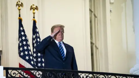 Getty Images Trump salutes the departing Marine One helicopter