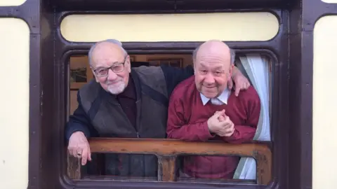 Lizzy Stroud Father and son Stephen and John West leaning out of the railway carriage window