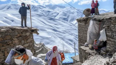 AFP Medical workers arrive at the village of Guneyyamac in eastern Turkey, as part of a vaccination expedition
