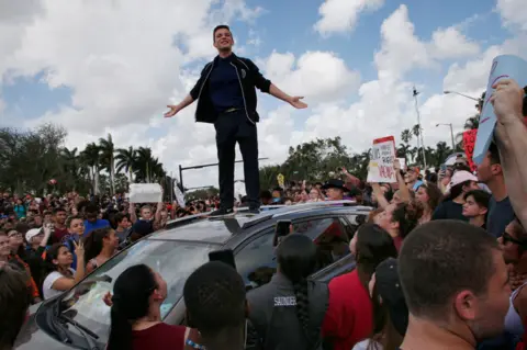 Getty Images Cameron Kasky addressing a rally at Marjory Stoneman Douglas High School after participating in a county wide school walk out