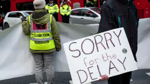 Getty Images Climate protesters from the Extinction Rebellion group hold placards and banners as they block traffic in Elephant and Castle