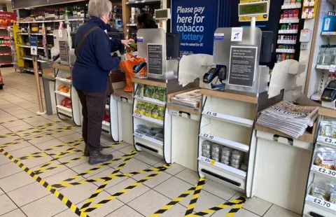 Reuters Taped-off areas for customers distance themselves from each other are seen at the checkout till area of a local Tesco store as the number of coronavirus disease cases (COVID-19) grow around the world, in London, Britain, March 21, 2020. REUTERS/Toby Melville