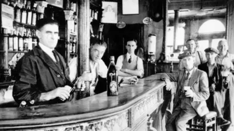 The McGurk family Patrick McGurk (third from left) pictured behind the bar of his family pub