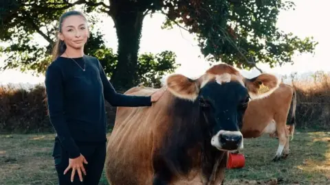 Ollie Jones  Zoe Marshall with one of her cows