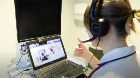 BTHFT A member of hospital staff carries out a remote consultation