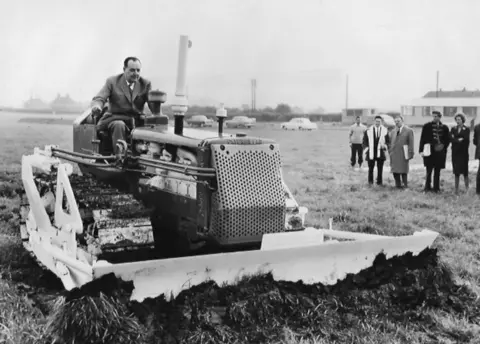 Tayto William Alexander cutting the turf in 1963 at Broxburn before his factory was built