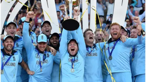 AFP/Getty Images Englands captain Eoin Morgan lifts the World Cup trophy as England players celebrate their win after the 2019 Cricket World Cup