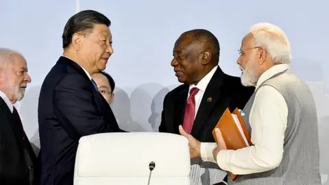 Getty Images Chinese President Xi Jinping (2nd L), South African President Cyril Ramaphosa (2nd R), and Indian Prime Minister Narendra Modi (R) attend the 15th BRICS Summit in Johannesburg, South Africa on August 24, 2023