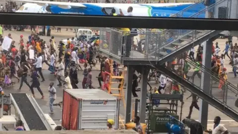 People entered the airport to bid farewell to Magufuli