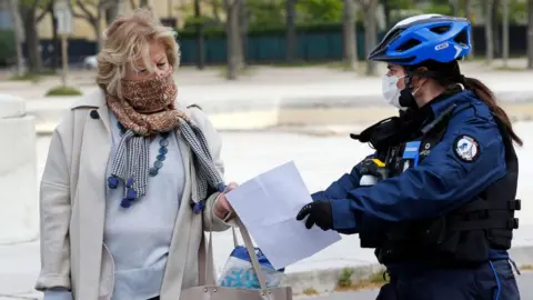 Getty Images Police officer questioning woman, Paris