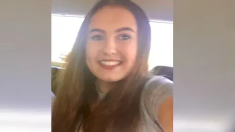 BBC A young woman with brown hair and a bright smile