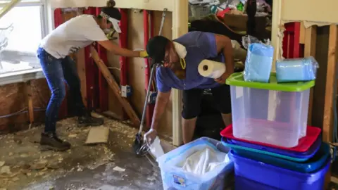 EPA A volunteer works with Barbara Wilson as she begins to clean her house flooded by Hurricane Harvey in the Hunterwoods Village area of Houston, Texas, 3 September 2017