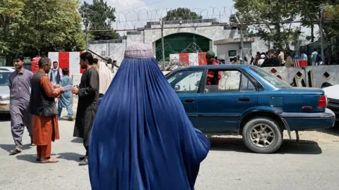EPA People gather outside the Pakistani embassy, to obtain a visa. after Taliban took over in Kabul, Afghanistan, 22 August 2021.